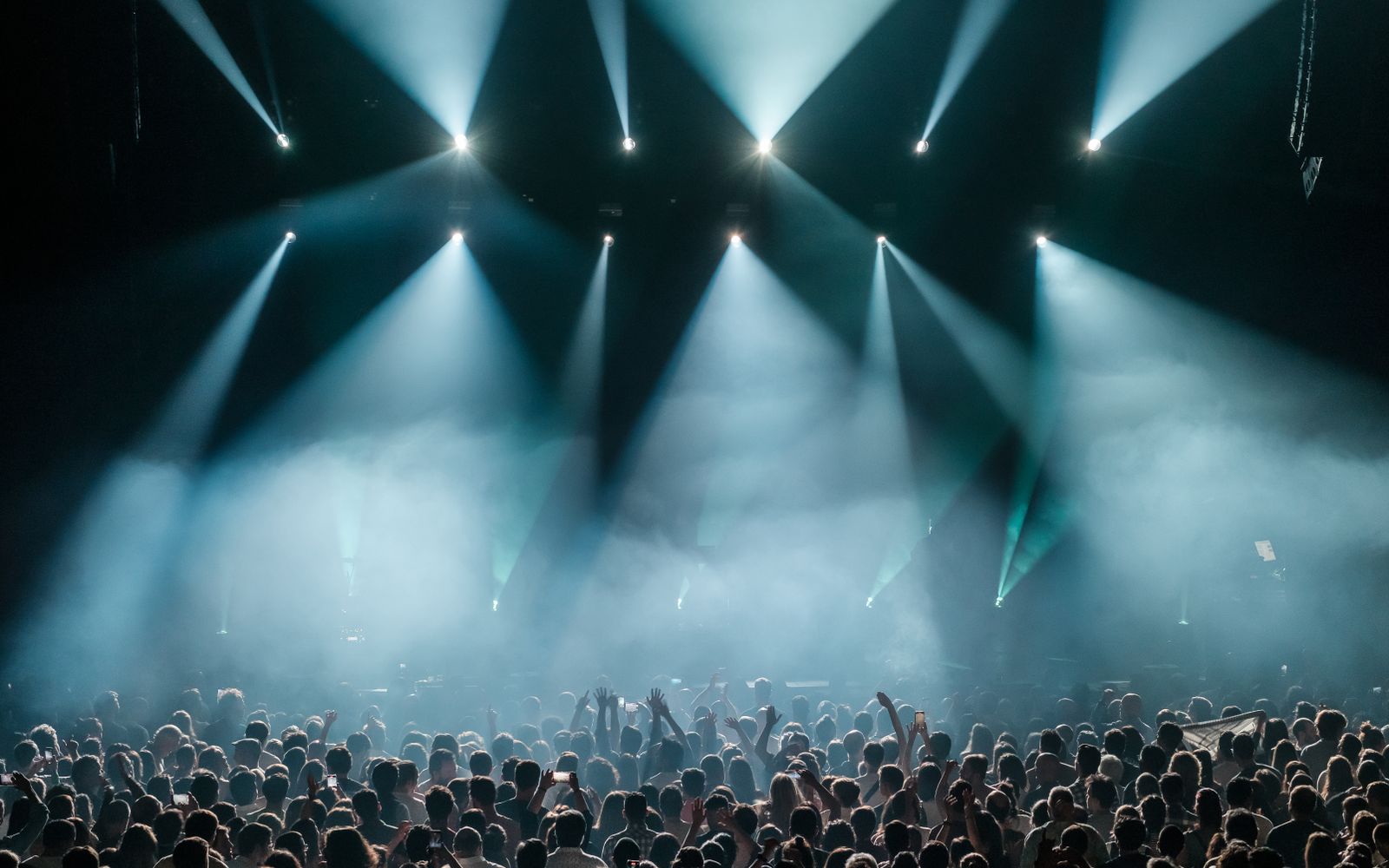 Concert crowd under bright stage lights